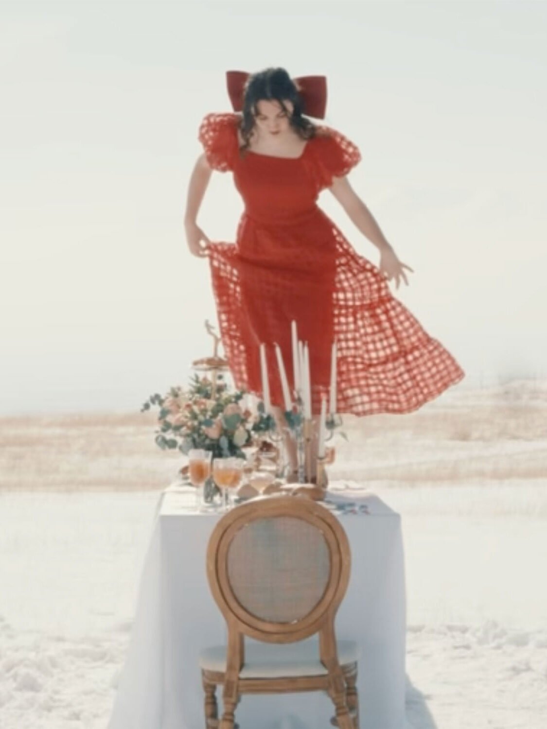 Attalie Anne in "Table for Two" Music Video - standing on top of a formal table set for two in the middle of a snow-covered field in Utah